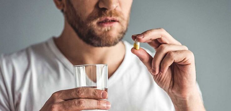A man is taking medication to treat prostatitis