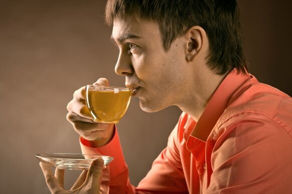 a man drinks herbal tea to treat prostatitis